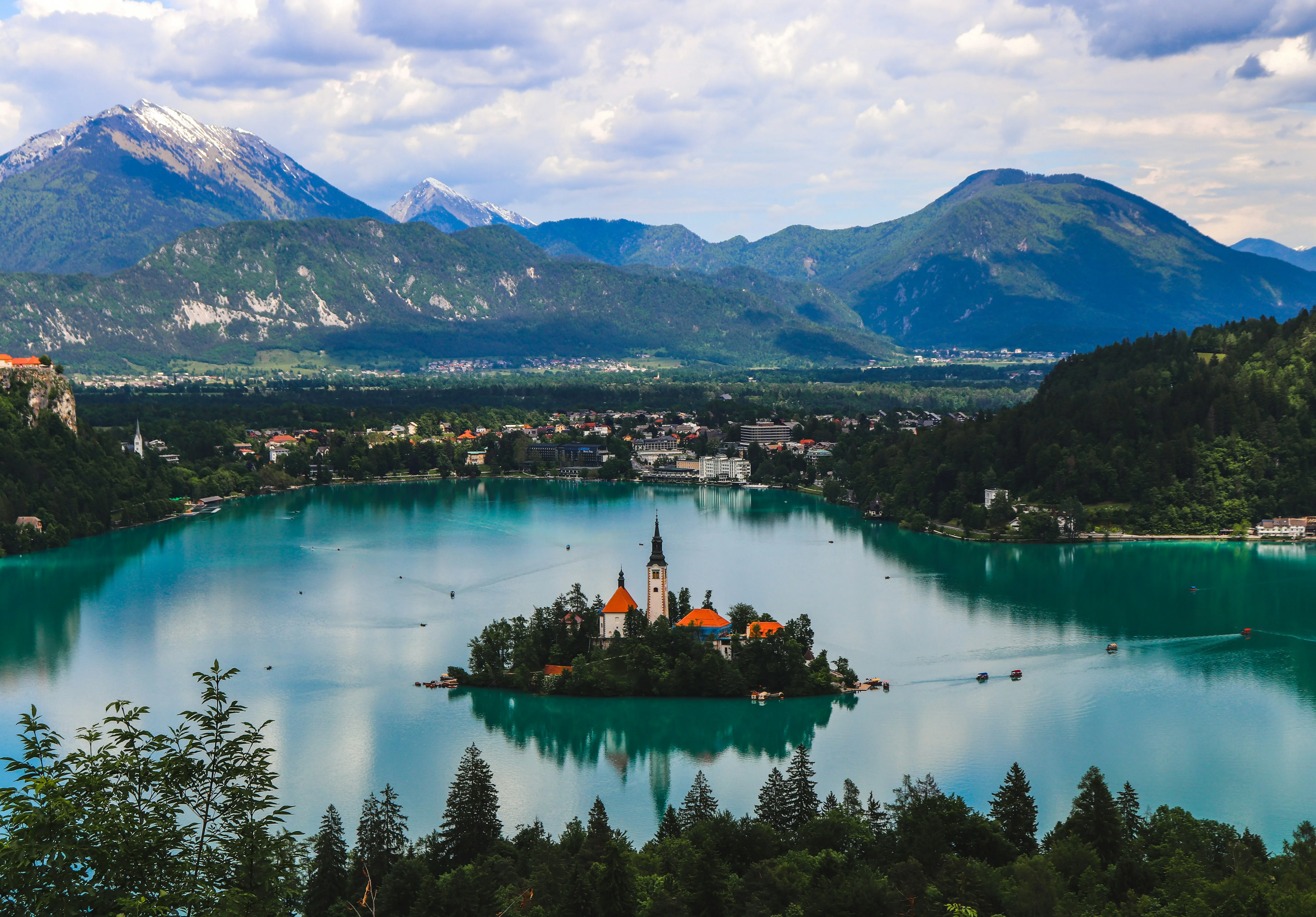 Lake Bled with its island church, framed by green trees and mountains